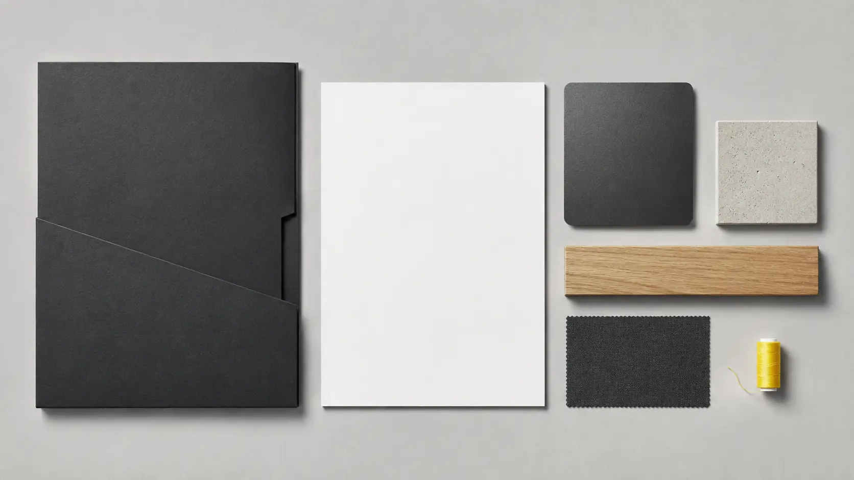 Palette d’application anthracite avec papier blanc, béton, chêne et petit accent jaune